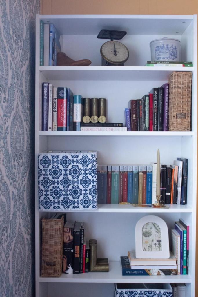 A bookcase is styled using the IKEA Billy Bookcase.
