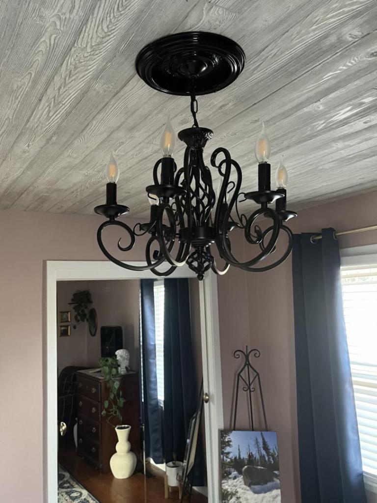 A DIY ceiling medallion is finished and installed in a master bedroom.