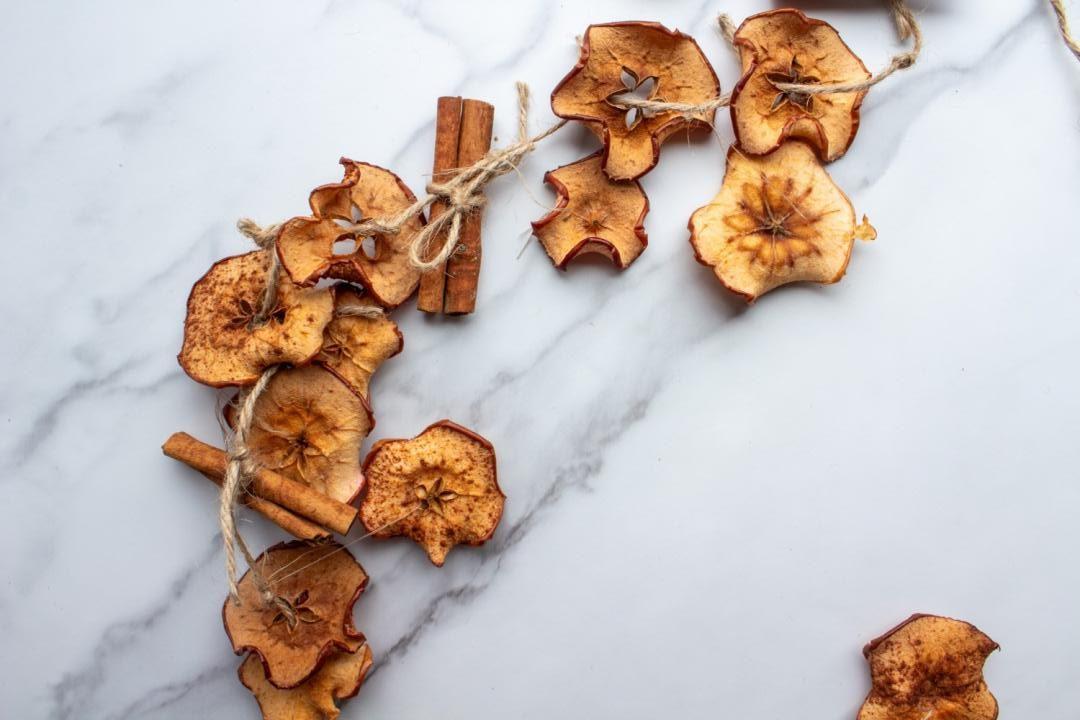 A completed apple and cinnamon garland is ready to be hung.