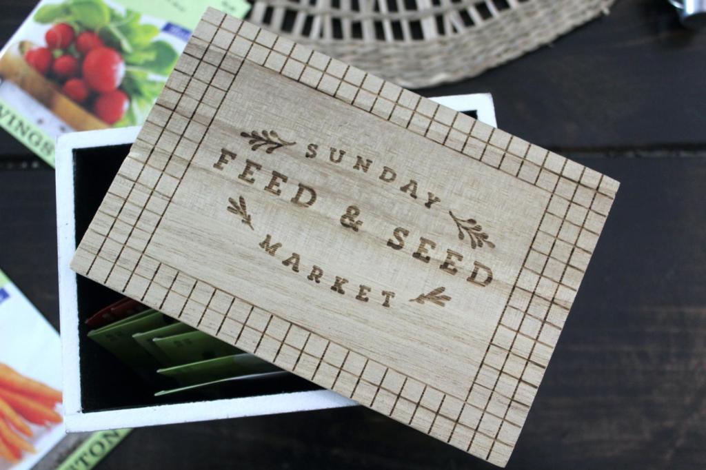 A box sits on a table for storing garden seeds.
