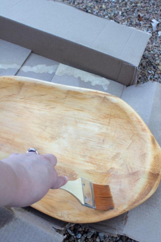 A woman adds a second coat of bleach after it dries.