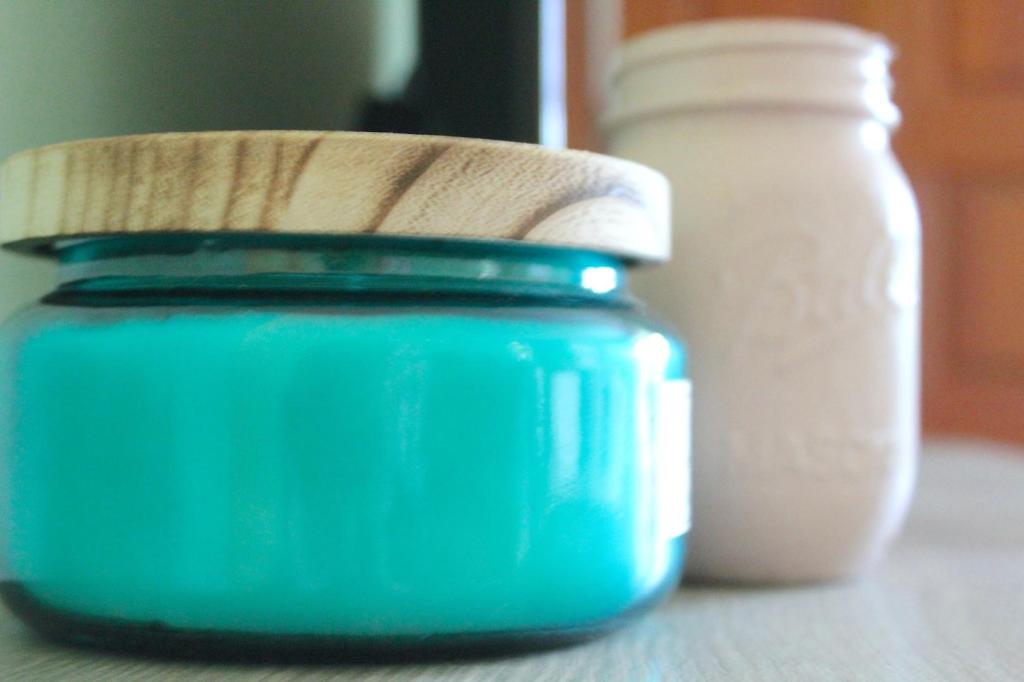 A blue candle brings about summer vibes with its beachy scent.