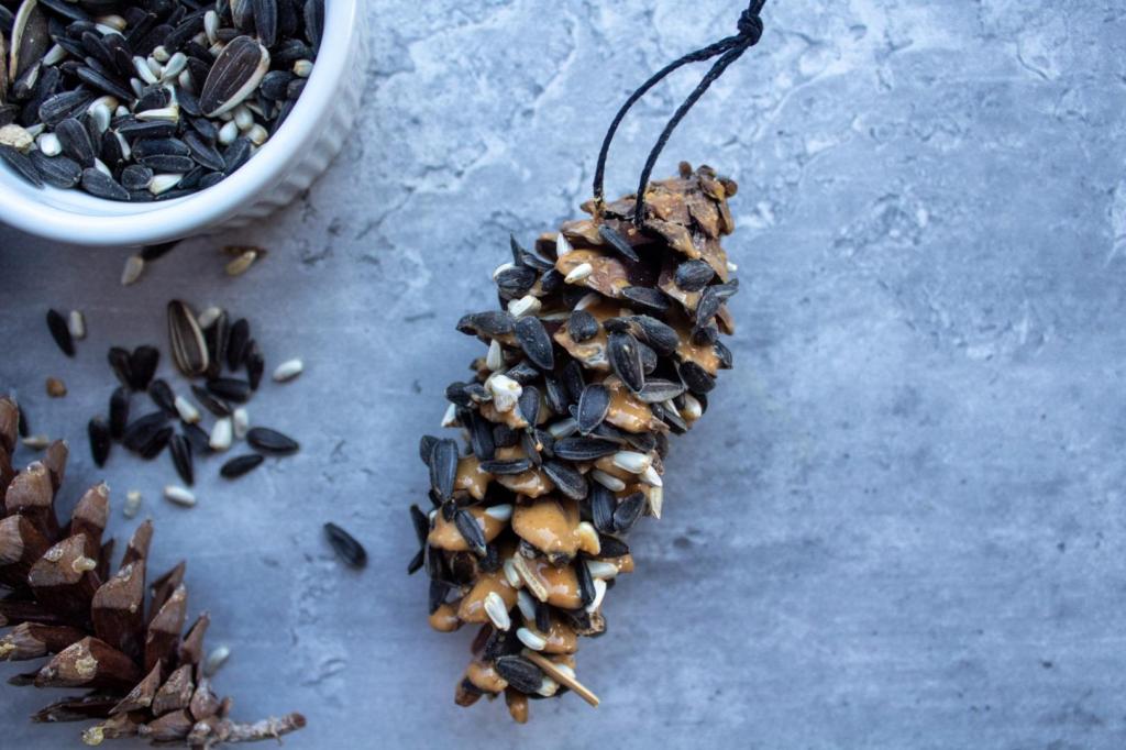 A DIY pine cone bird feeder is laying near a cup of birdseed and pine cones.