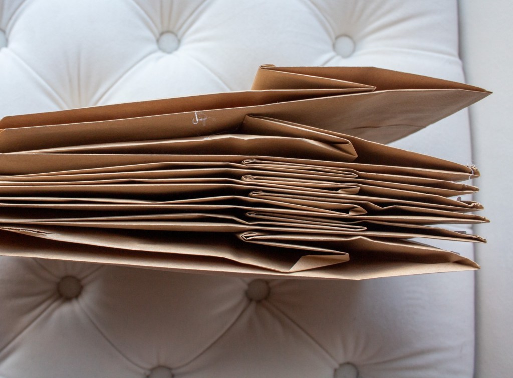 Paper sacks are glued and pressed together.