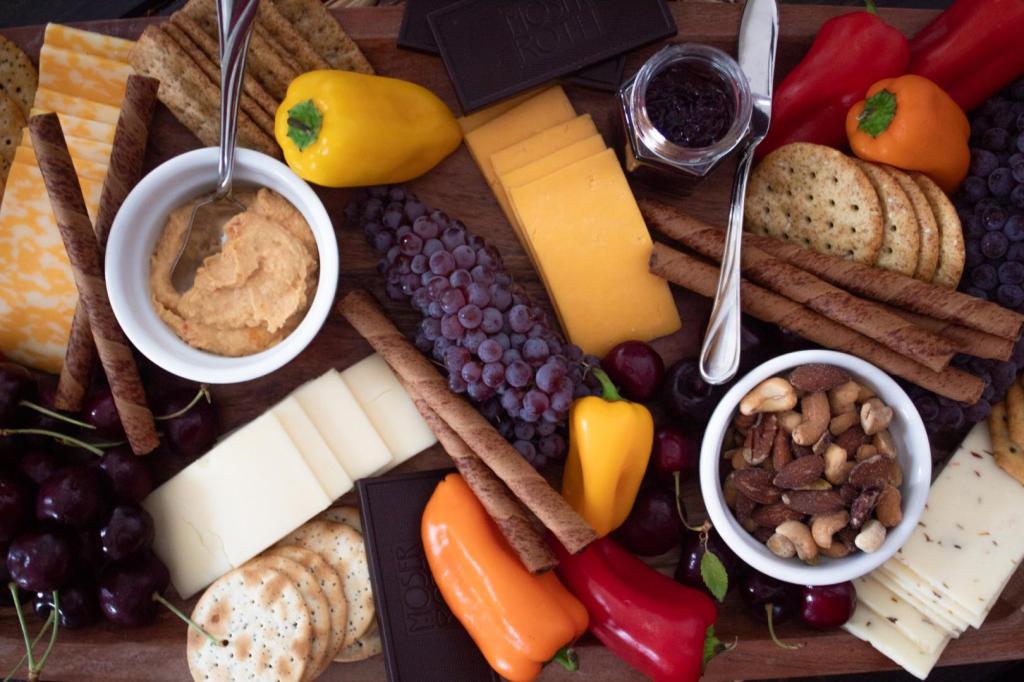 A vegetarian charcuterie board has a spread of fruits, nuts, dips, cheeses, and more.