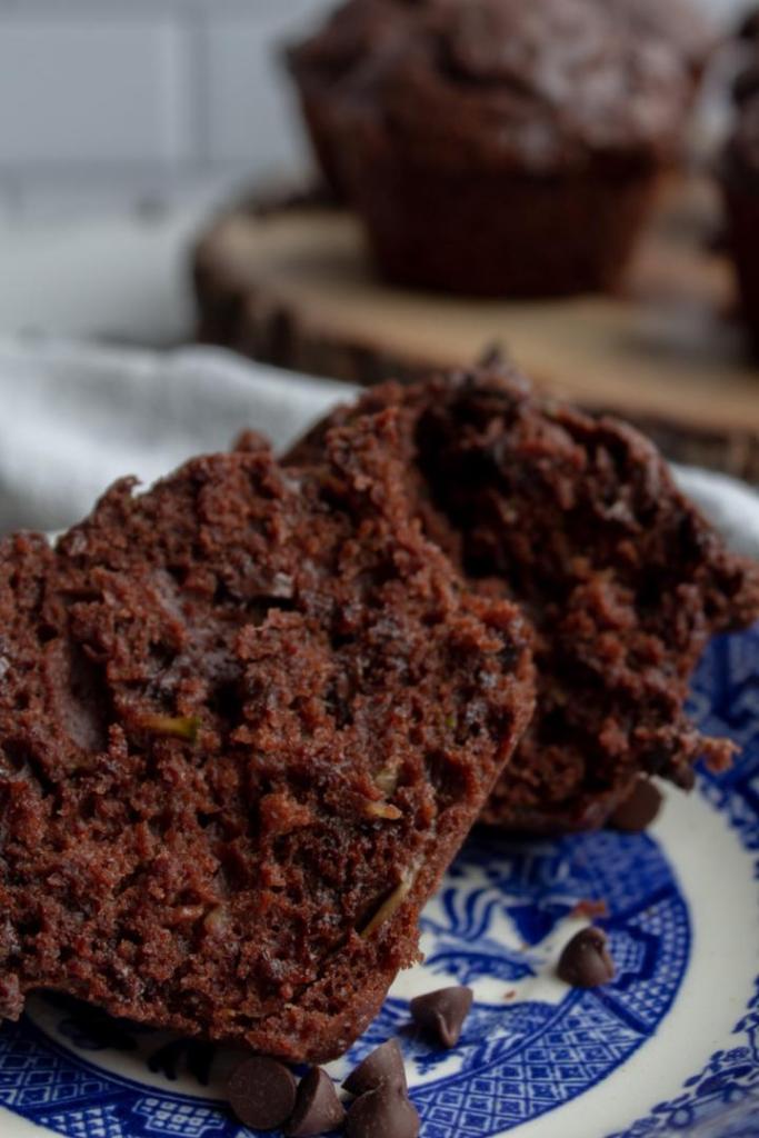 Zucchini chocolate chip muffins are split and served.