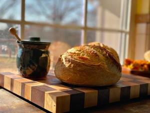 A loaf of sourdough bread sits on a kitchen counter.