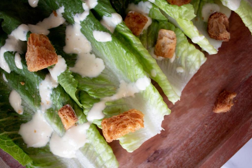 Caesar salad is served up on a platter.