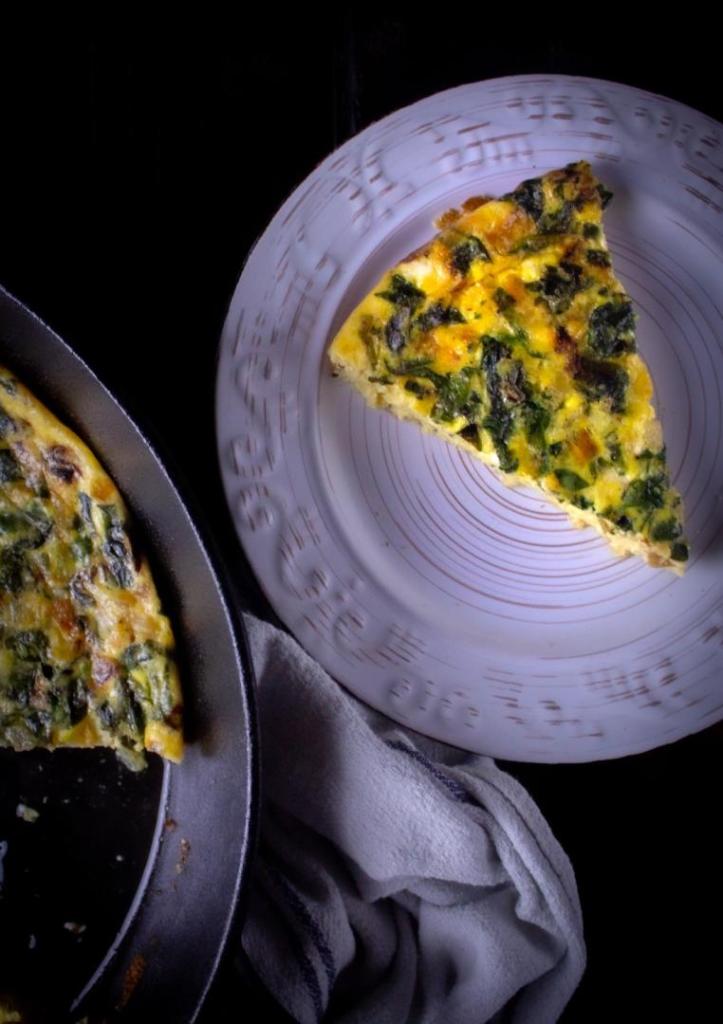 A quiche is sliced and served.