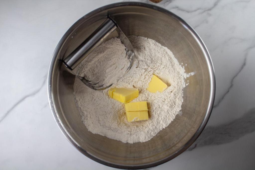Butter cubes are cut into the dough for biscuits.