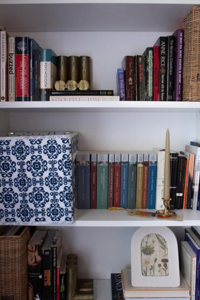 The Billy Bookcase styling is complete with books, storage bins, art, and vintage pieces.