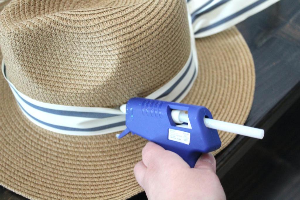 A wreath gets hot glue added to it.