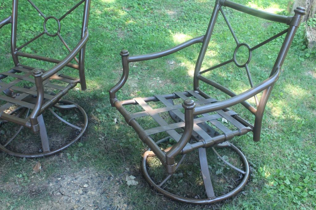 Metal patio chairs have been painted a dark brown color.