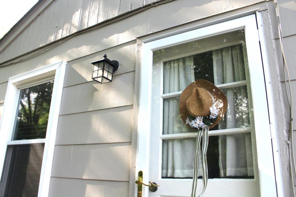 A DIY summer wreath stands out on a cottage owner's patio.