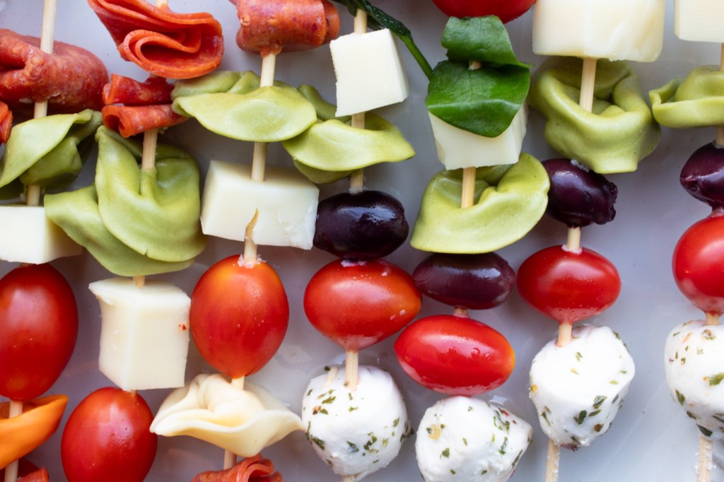 Italian antipasti skewers are served with lots of vibrant colors.