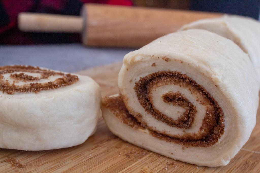Cinnamon roll dough is sliced into 12 pieces.