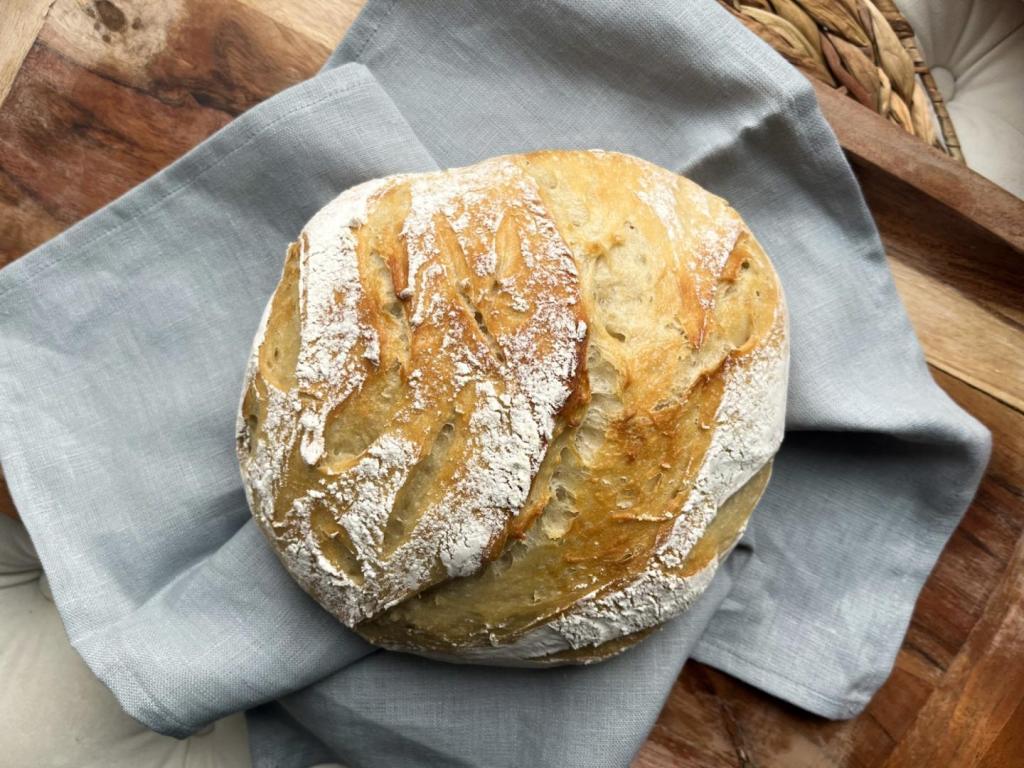 Easy artisan bread rests on a wooden tray.