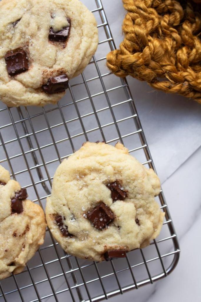 Chocolate chunk cookies are ready to be devoured from a cooling rack.