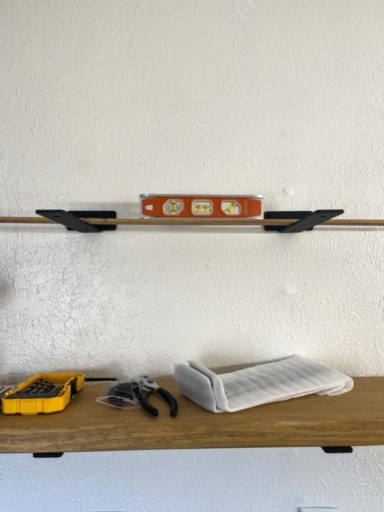 A leveler is used to check how level brackets are to one another.