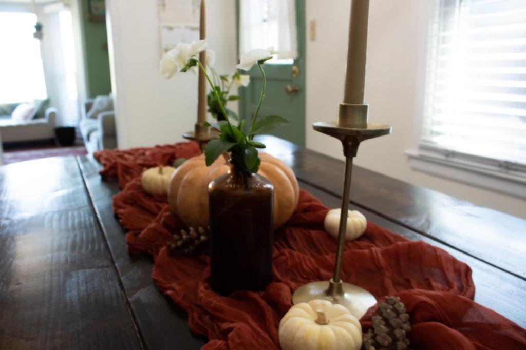 Candles add both height and scent to a dramatic fall setting on a tabletop.