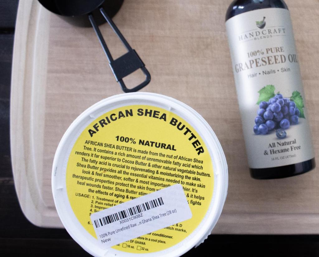 Shea butter and other ingredients sit on a tabletop before starting a recipe.