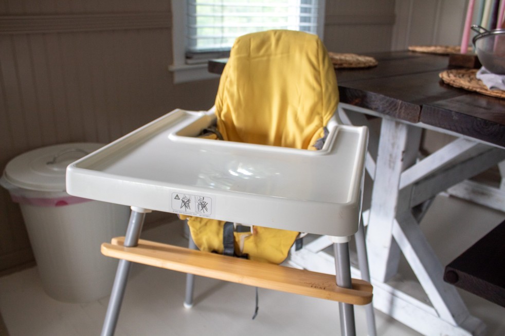 The IKEA antilop high chair is shown with a yellow cushion seat cover.