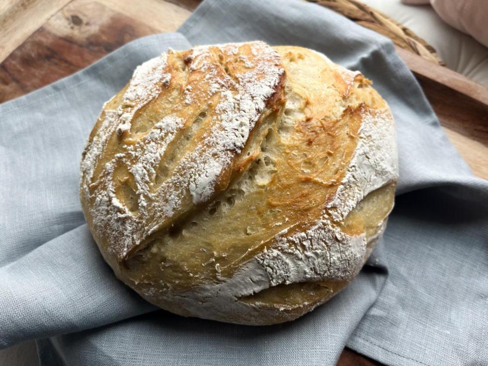 Easy artisan bread is ready to be sliced and served.