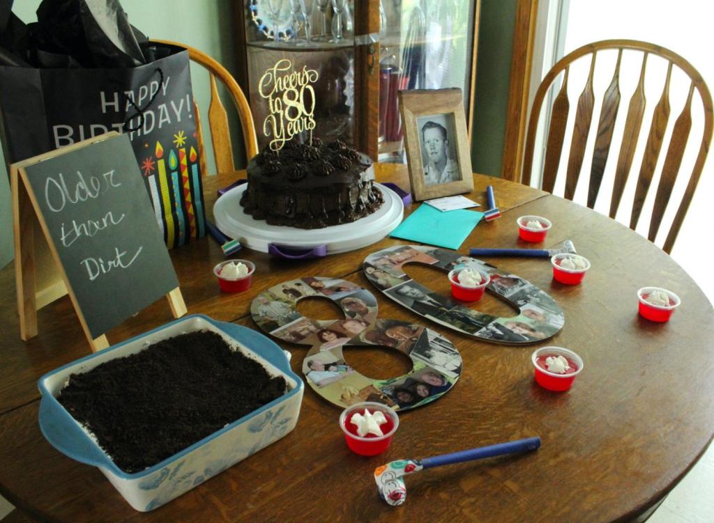 Jell-O shots are scattered about a decorated table for a birthday party.