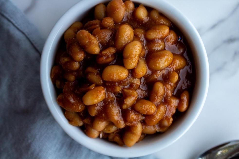 Crockpot vegetarian baked beans are served in a mini white ramekin.