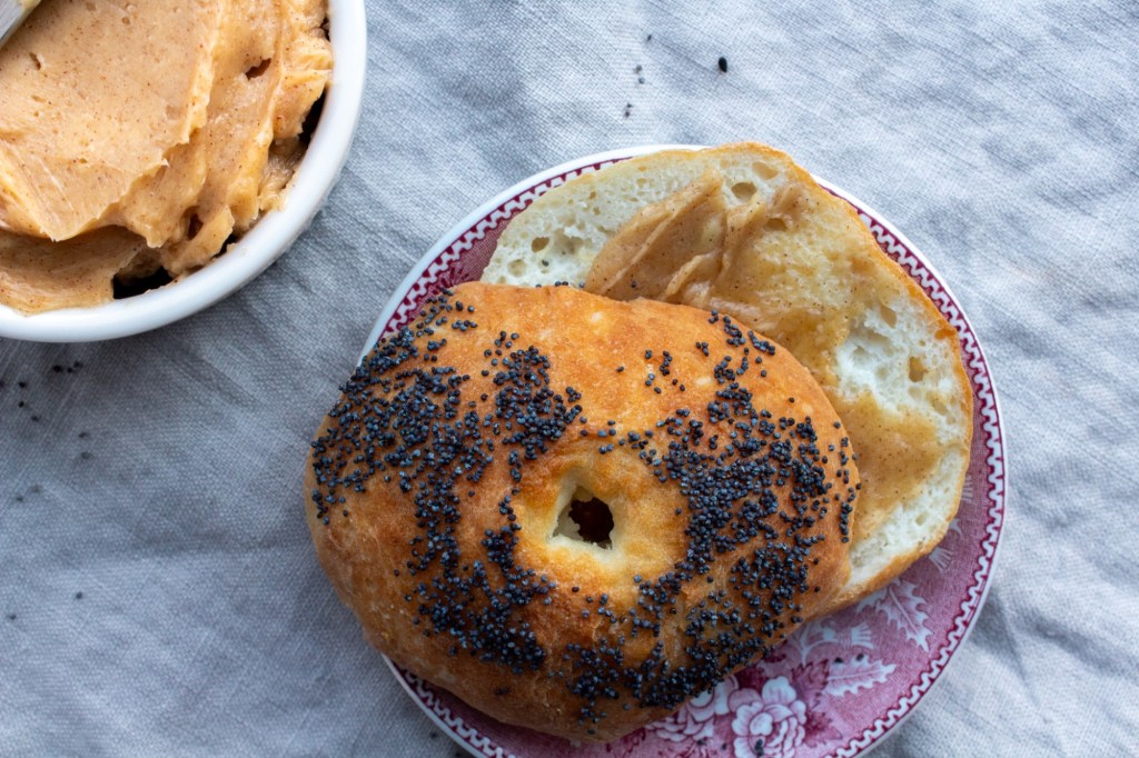 Cinnamon honey butter from Texas Roadhouse is smothered on a poppy seed bagel.
