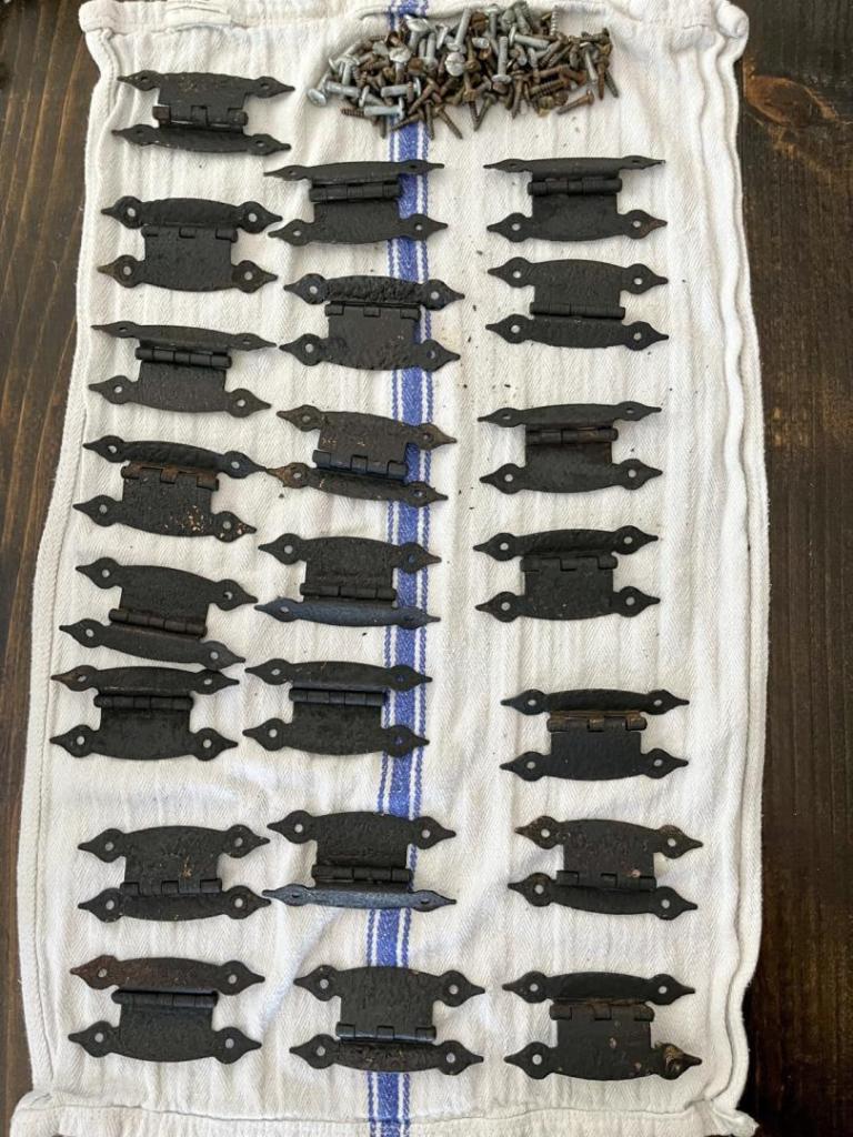 Black spray paint is applied as a primer for the Rub 'n Buff.