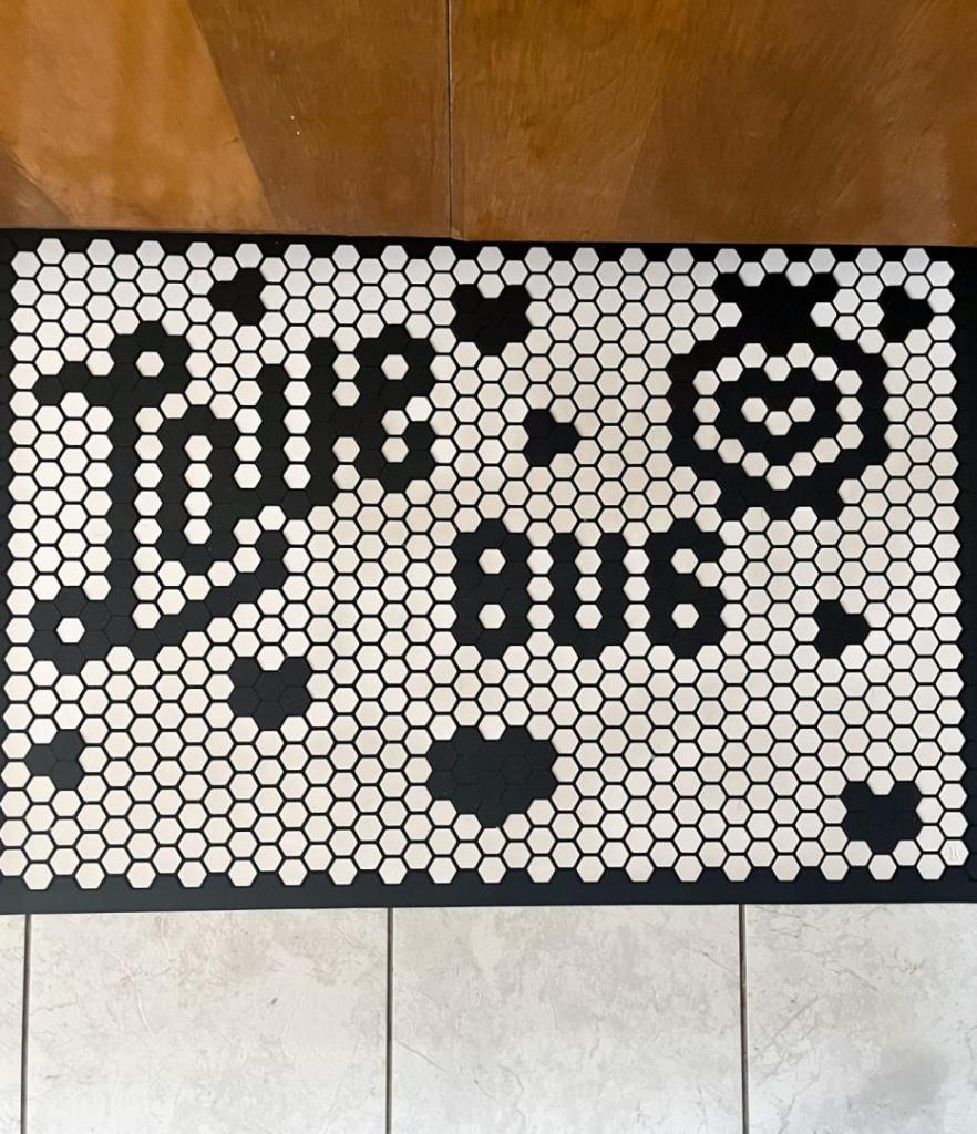 A tile mat says "love bug" for Valentine's Day.