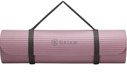 A purple yoga mat is rolled up.