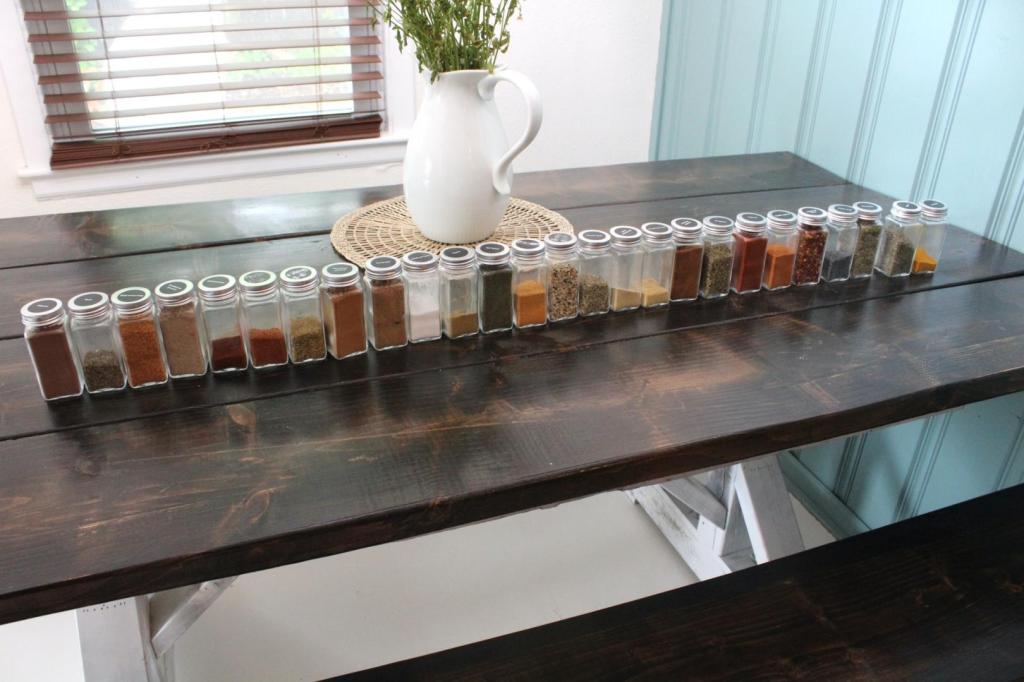 Spices are all lined up across a dining table after some spice rack organization.