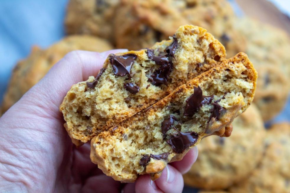 This easy lactation cookies recipe shows a cookie split in half with all the melted chocolate inside glistening.