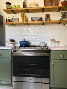 A DIY subway tile backsplash is shown above an oven and cabinets.