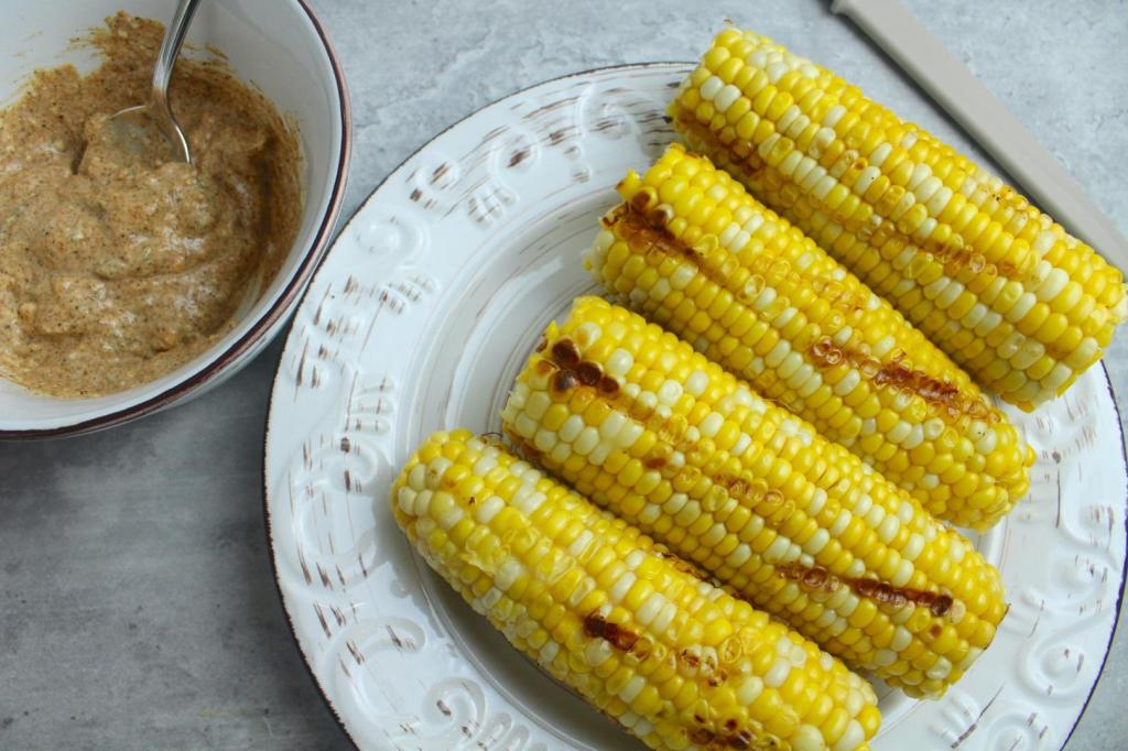 Corn has grill marks on it after being cooked on a grill.