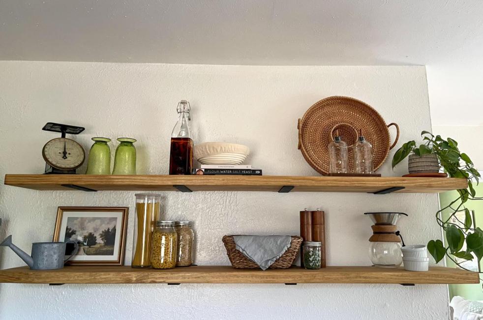 Kitchen floating shelves show decor and practical kitchen items in a cottage kitchen.