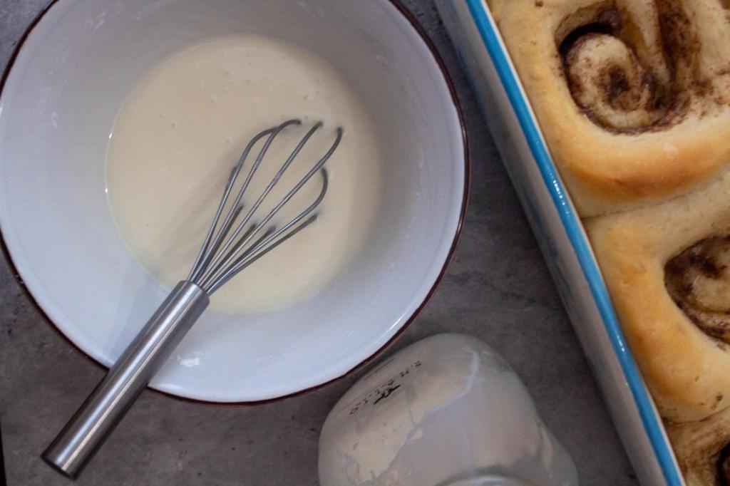 Icing is whisked together in a small bowl.