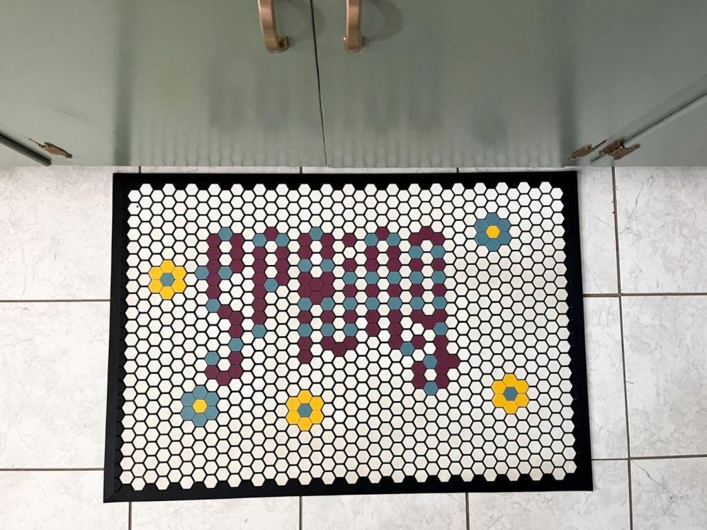 A letterfolk tile mat shows the word "spring" with flowers on it.