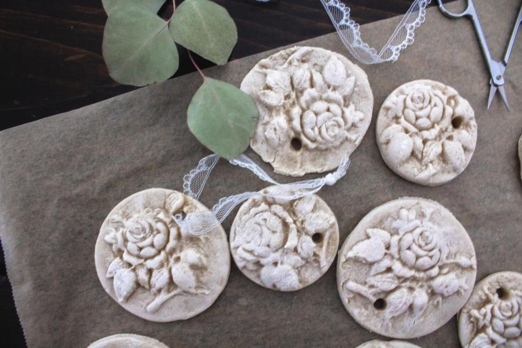 Salt dough Christmas ornaments have ribbon added to them.