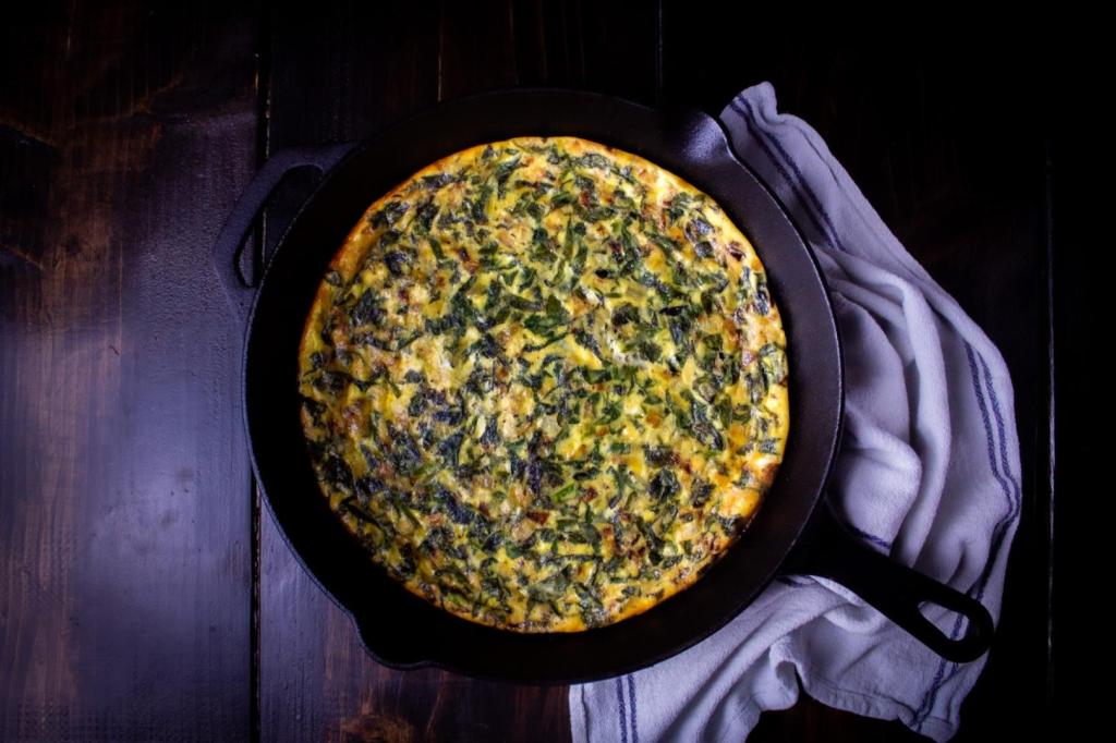 Spinach Mozzarella Crustless quiche is filled with veggies and cheese and served in a cast-iron skillet.