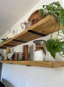 Easy diy kitchen floating shelves are on display in a cottage kitchen.