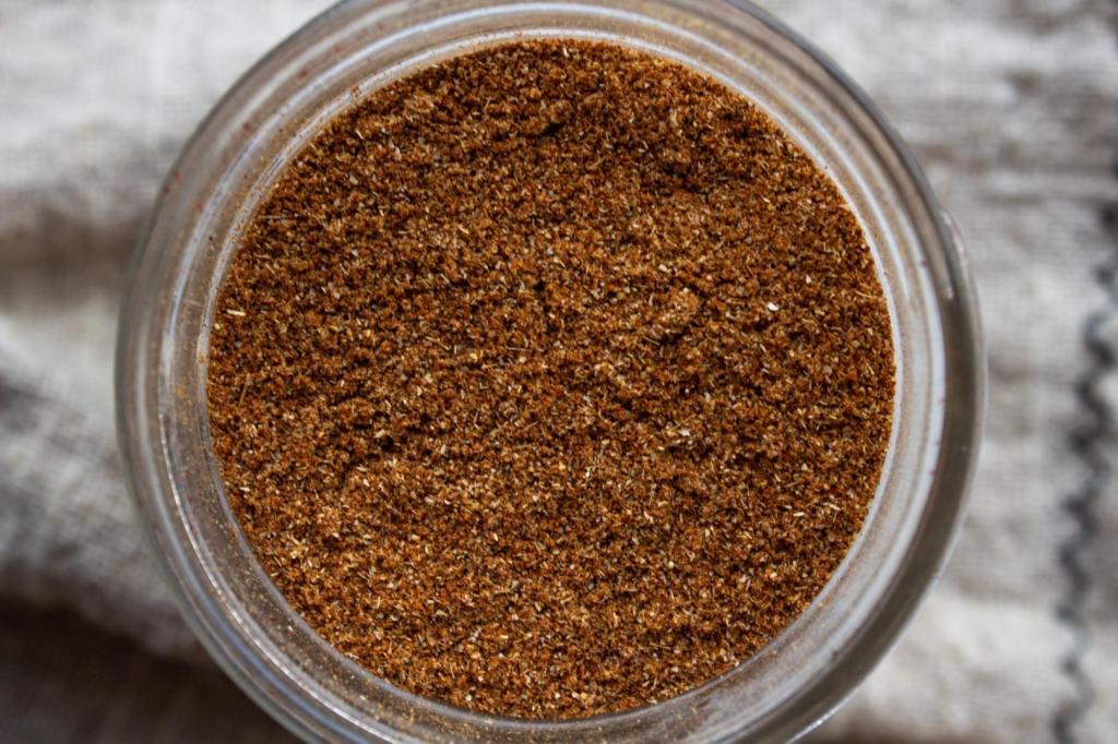Taco seasoning is shown up close in a jar.