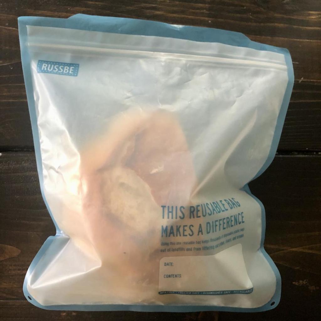 A portion of a loaf of bread is being stored inside a reusable ziplock bag for a low waste hack.