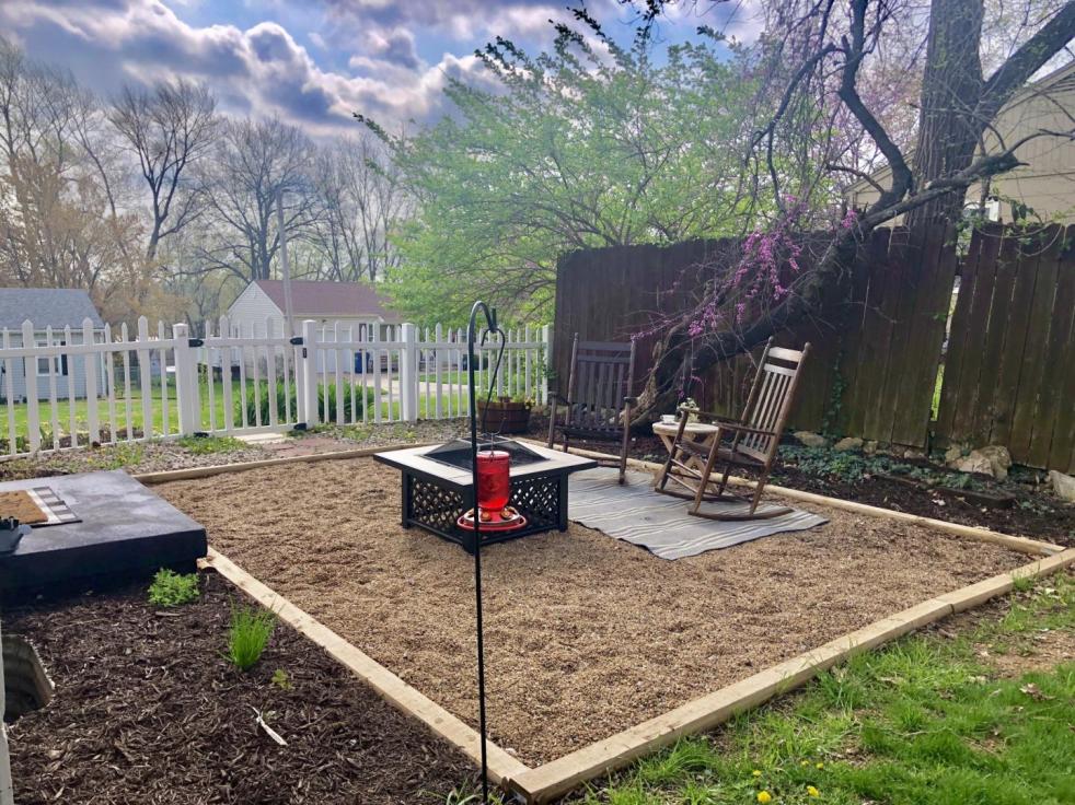 Spring patio decor is added to a pea gravel patio for subtle hints of spring.