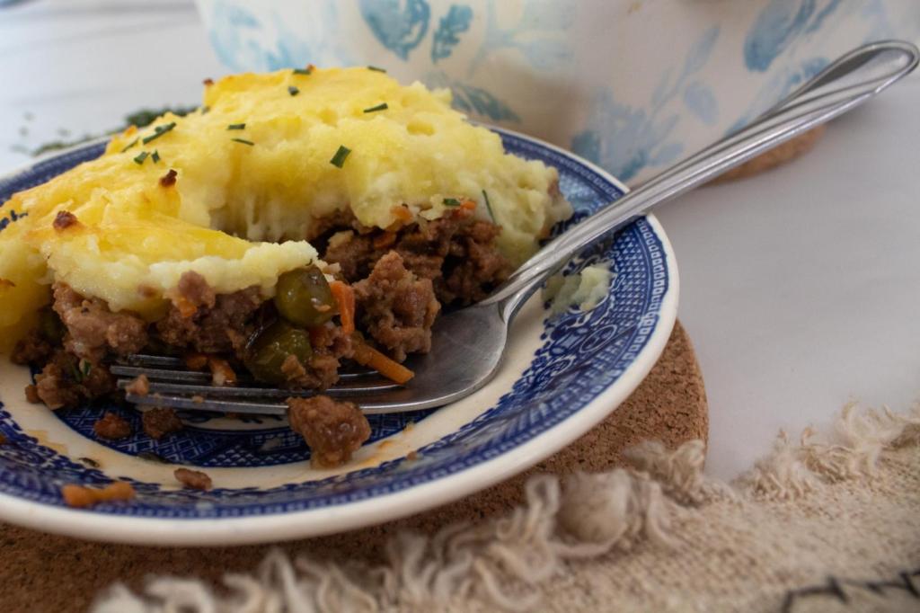 Shepherd's pie is cut into with a fork for eating.