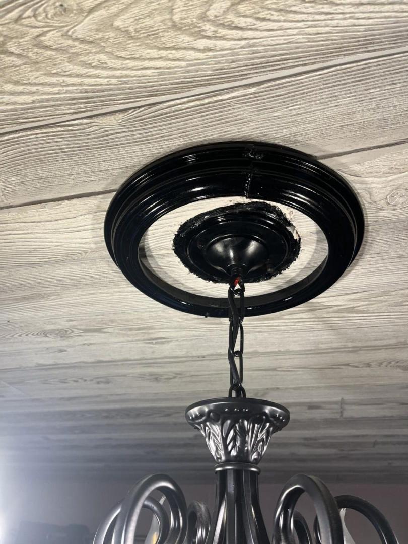 A chandelier has a frame added around it.