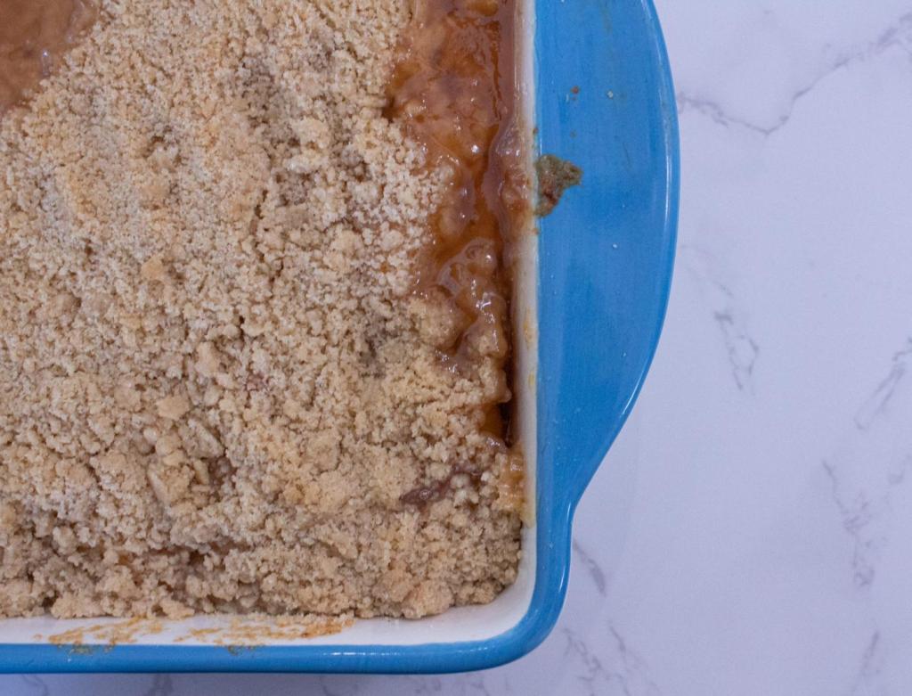 A peach crumble bubbles after being pulled out of the oven.