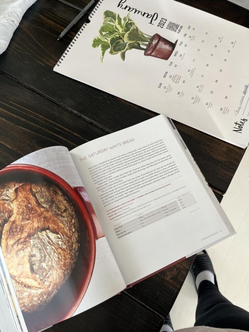 A bread making book is opened on a table.